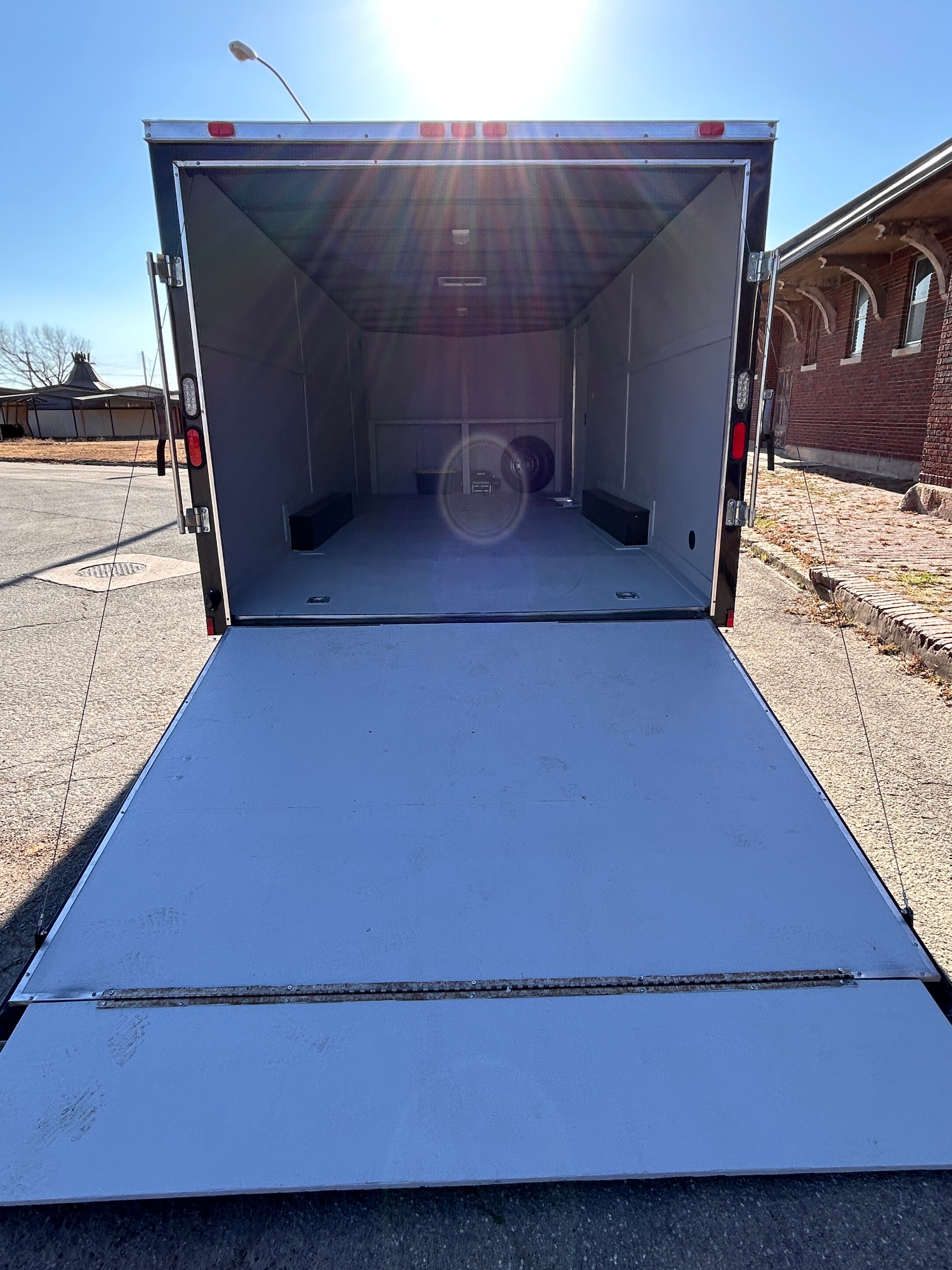 Enclosed trailer ramp door open for loading